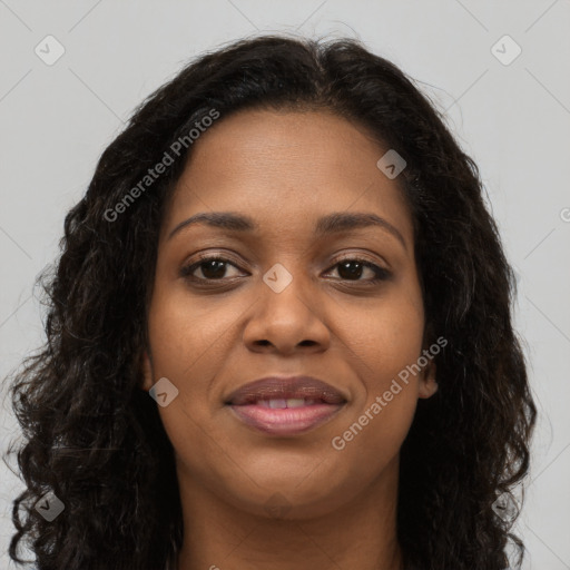 Joyful black young-adult female with long  brown hair and brown eyes