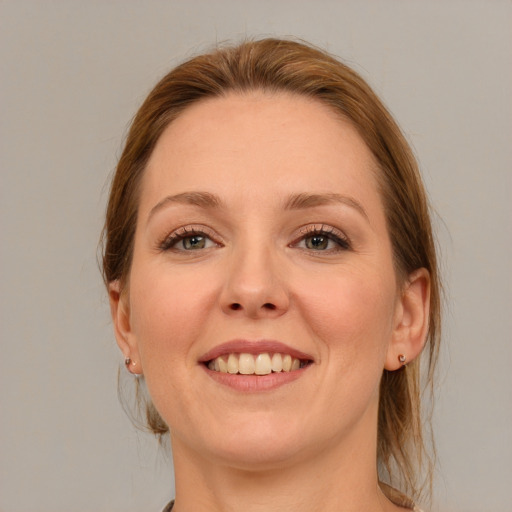 Joyful white young-adult female with medium  brown hair and blue eyes