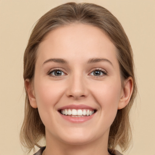 Joyful white young-adult female with medium  brown hair and green eyes