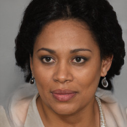 Joyful black adult female with medium  brown hair and brown eyes