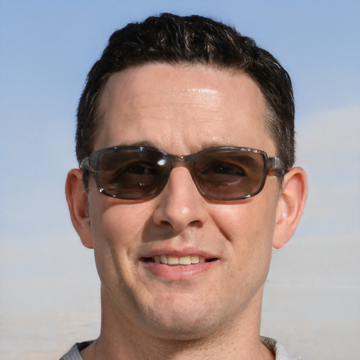 Joyful white adult male with short  brown hair and brown eyes