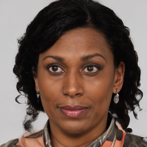 Joyful black adult female with medium  black hair and brown eyes