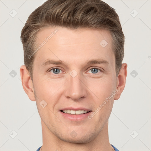 Joyful white young-adult male with short  brown hair and grey eyes