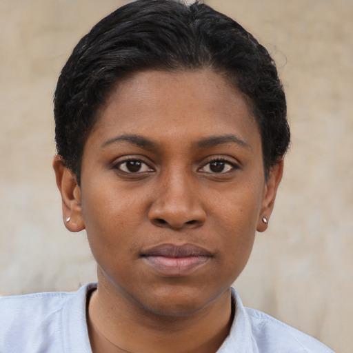 Joyful black young-adult female with short  brown hair and brown eyes