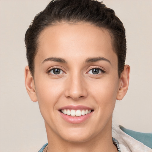 Joyful white young-adult female with short  brown hair and brown eyes