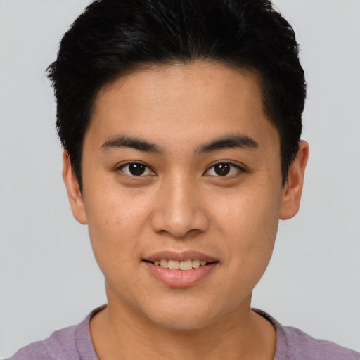 Joyful asian young-adult male with short  brown hair and brown eyes