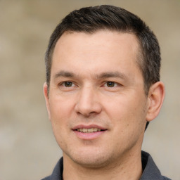 Joyful white adult male with short  brown hair and brown eyes