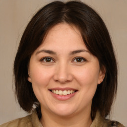 Joyful white adult female with medium  brown hair and brown eyes