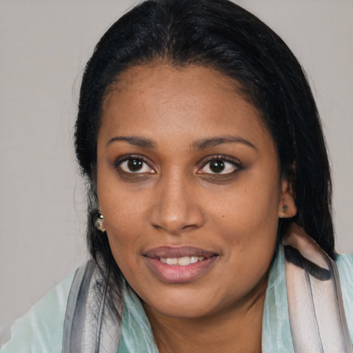 Joyful black young-adult female with medium  black hair and brown eyes