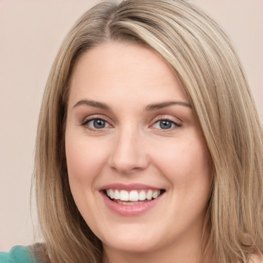 Joyful white young-adult female with long  brown hair and green eyes