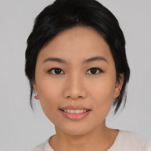 Joyful asian young-adult female with medium  black hair and brown eyes