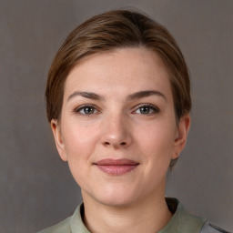 Joyful white young-adult female with short  brown hair and grey eyes