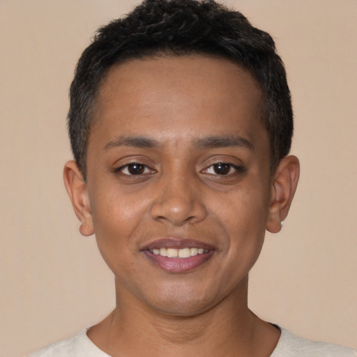 Joyful black young-adult male with short  black hair and brown eyes
