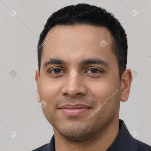 Joyful white young-adult male with short  black hair and brown eyes