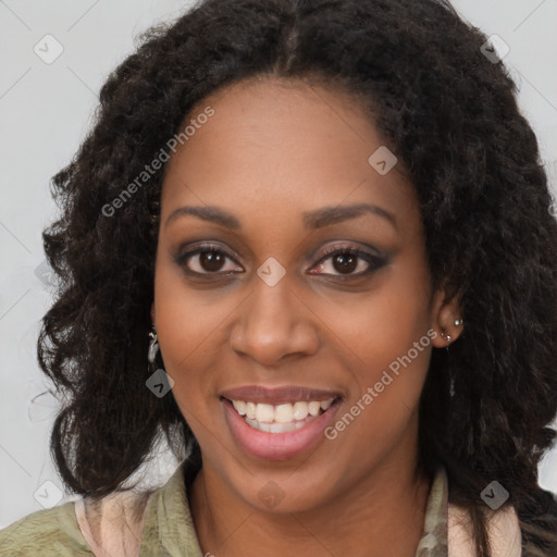 Joyful black young-adult female with long  black hair and brown eyes