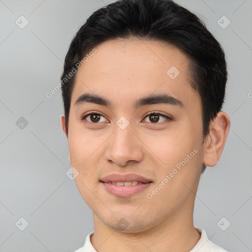 Joyful asian young-adult male with short  brown hair and brown eyes