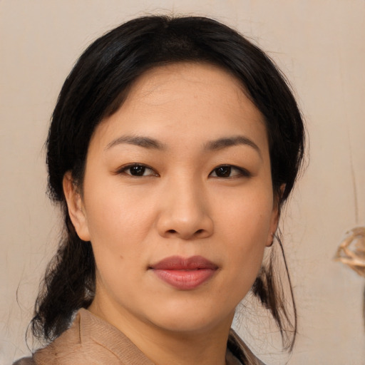 Joyful asian young-adult female with medium  brown hair and brown eyes