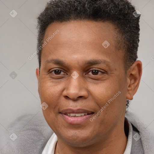 Joyful latino adult male with short  brown hair and brown eyes