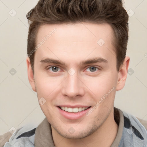 Joyful white young-adult male with short  brown hair and grey eyes