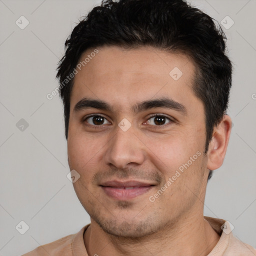 Joyful white young-adult male with short  black hair and brown eyes