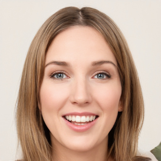 Joyful white young-adult female with medium  brown hair and green eyes