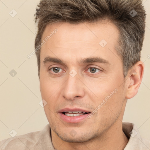 Joyful white adult male with short  brown hair and brown eyes