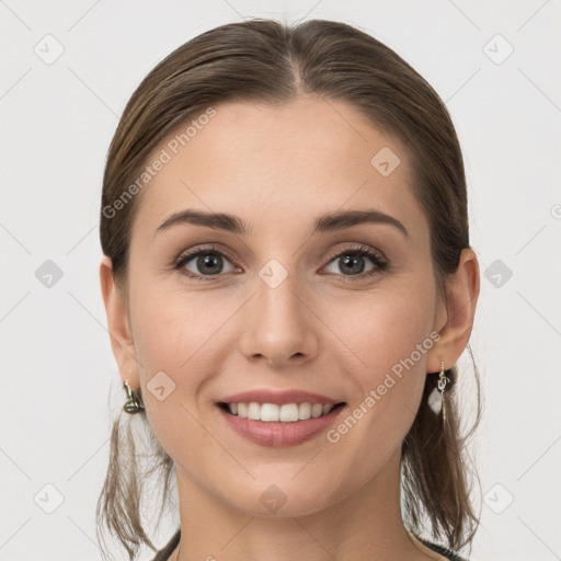 Joyful white young-adult female with medium  brown hair and grey eyes