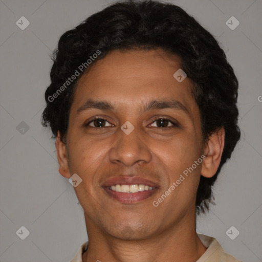 Joyful latino young-adult male with short  brown hair and brown eyes