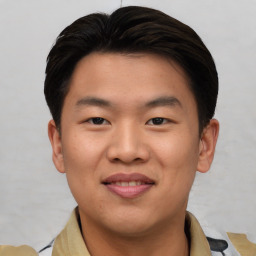 Joyful asian young-adult male with short  brown hair and brown eyes