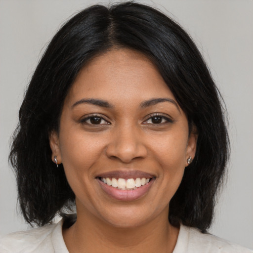Joyful black young-adult female with medium  black hair and brown eyes