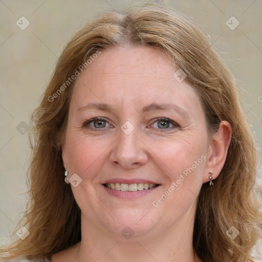 Joyful white adult female with medium  brown hair and blue eyes