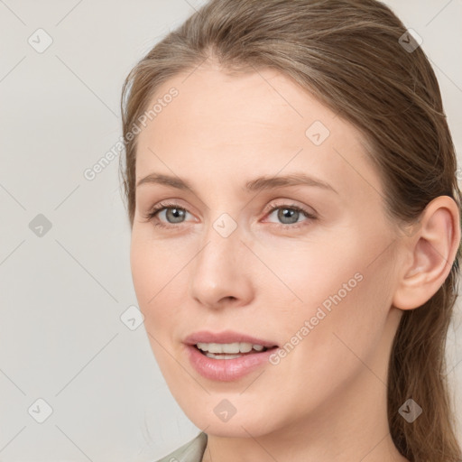 Joyful white young-adult female with long  brown hair and blue eyes