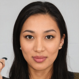 Joyful latino young-adult female with long  brown hair and brown eyes