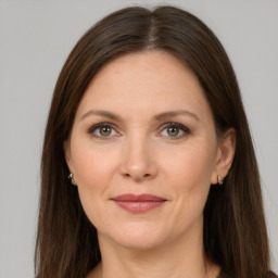 Joyful white adult female with long  brown hair and grey eyes