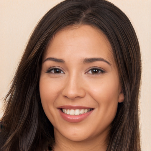 Joyful white young-adult female with long  brown hair and brown eyes