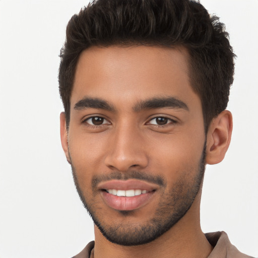 Joyful latino young-adult male with short  brown hair and brown eyes