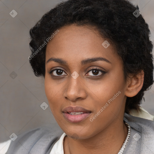 Joyful black young-adult female with short  black hair and brown eyes