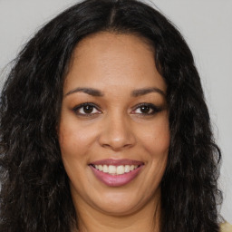 Joyful latino young-adult female with long  brown hair and brown eyes