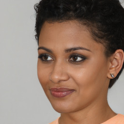 Joyful latino young-adult female with short  brown hair and brown eyes