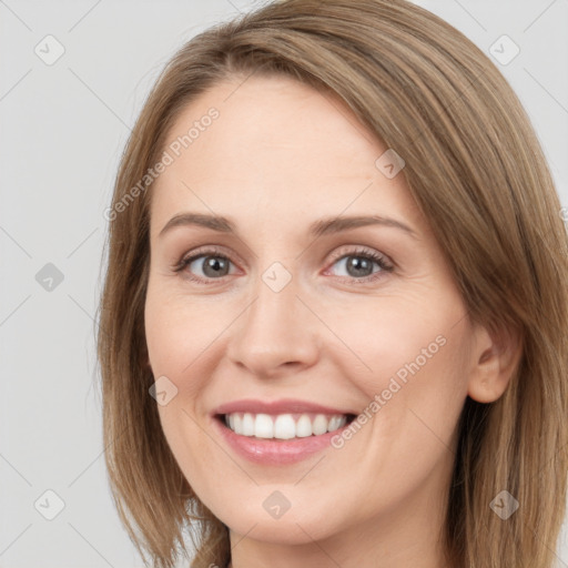 Joyful white young-adult female with long  brown hair and grey eyes