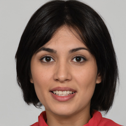 Joyful white young-adult female with medium  black hair and brown eyes
