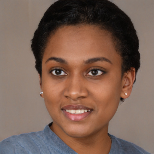 Joyful black young-adult female with short  black hair and brown eyes
