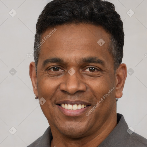 Joyful latino adult male with short  black hair and brown eyes