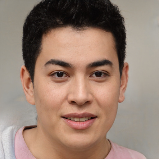 Joyful latino young-adult male with short  brown hair and brown eyes