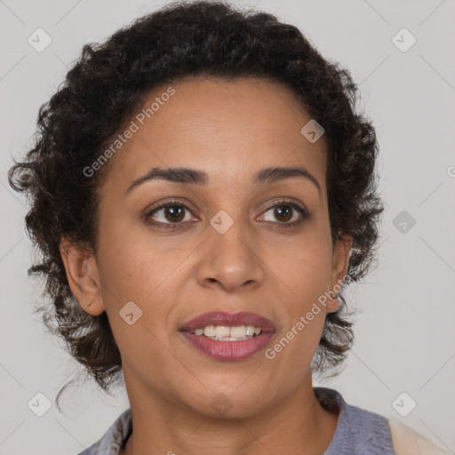 Joyful black adult female with medium  brown hair and brown eyes