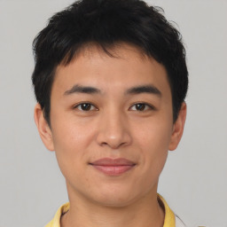 Joyful asian young-adult male with short  brown hair and brown eyes