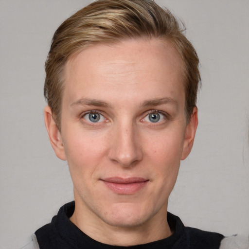 Joyful white young-adult female with short  brown hair and blue eyes