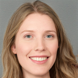 Joyful white young-adult female with long  brown hair and blue eyes