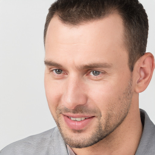 Joyful white adult male with short  brown hair and brown eyes