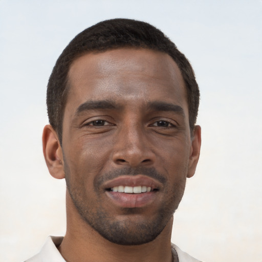 Joyful black young-adult male with short  brown hair and brown eyes